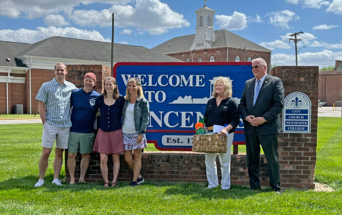 Movin' in with talent - McKenna and Bryce Shamburg (pictured left with parents Gary and Karen Goss) are the first to move to Vincennes as part of the Knox County Make My Move program. The couple moved to Knox County from Utah. Vincennes Mayor Joe Yochum (far right) and Mary Jo Wallin-Orlowski, Director of Business Development for Knox County Indiana Economic Development, officially welcomed the couple with a gift basket from Knox County organizations and an incentive check on May 13. "We have well over 100 people considering a move to Knox County through the Make My Move initiative," said Wallin-Orlowski. "Several offers have been made and we're pleased with the progress." The Make My Move program directly impacts popluation growth for the county. For more information about the Knox County MakeMyMove program, visit: https://knoxcountyindiana.com/knox-county-launches-opportunity-knox-talent-offensive-with-competitive-makemymove-program/